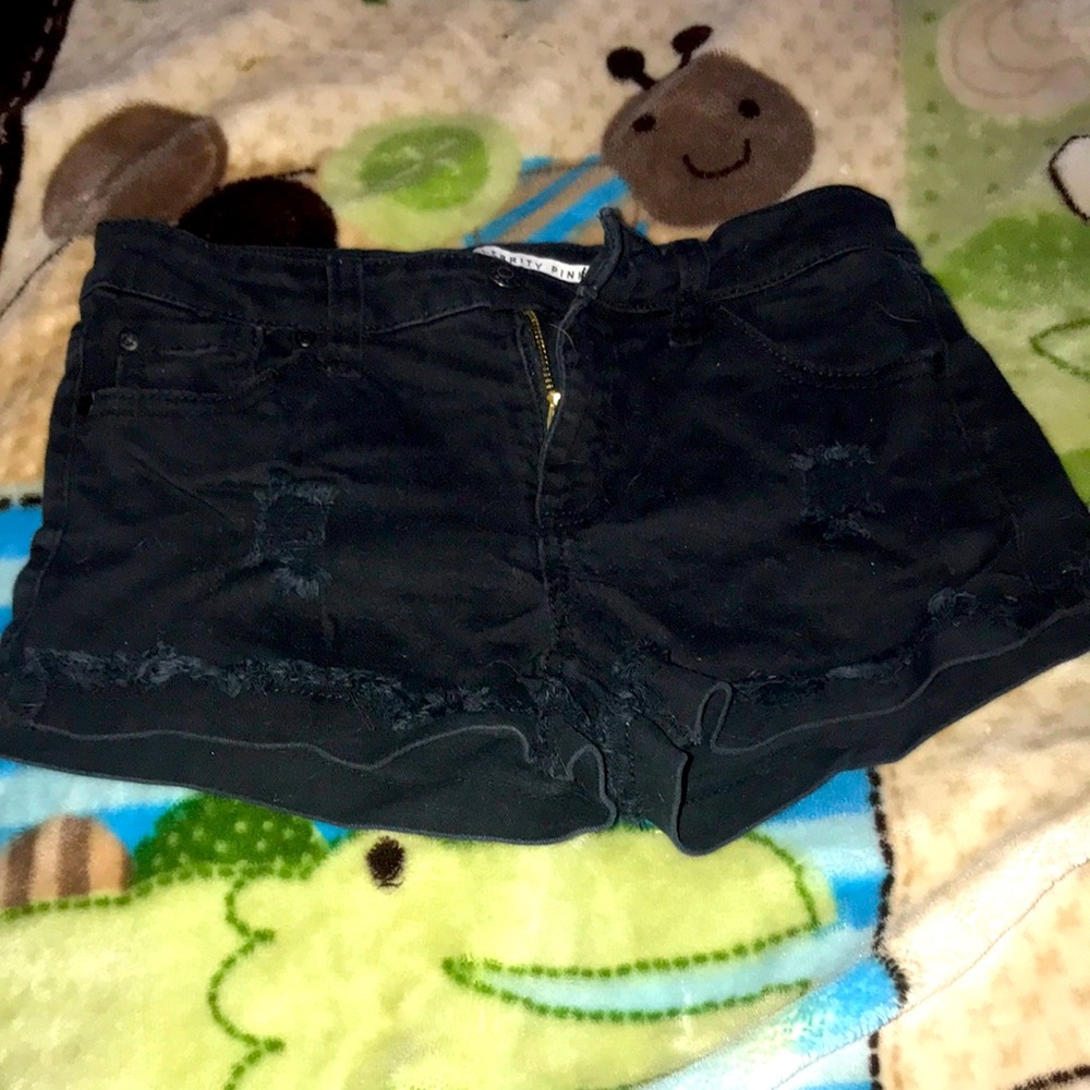 Woman’s low waisted black distressed jean shorts